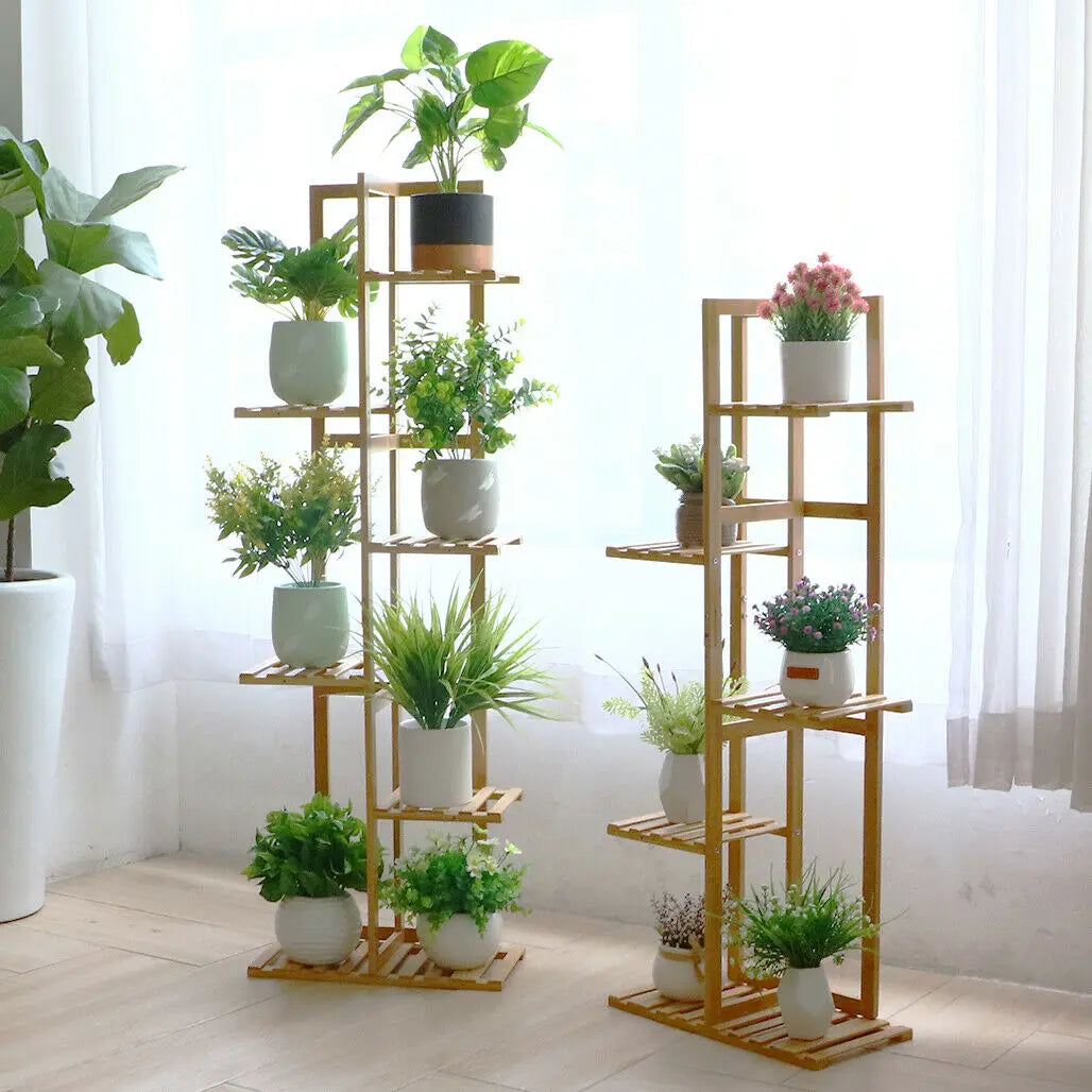 Modern bamboo plant shelf for home with multiple tiers holding green and flowering potted plants